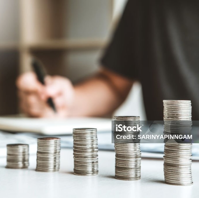 Homme utilisant la calculatrice calculant des factures